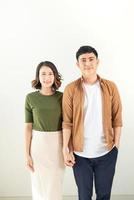 Portrait Of Happy Young Loving Couple Looking At Camera Isolated On White Background photo