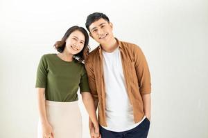 Portrait of young couple smiling on white background photo