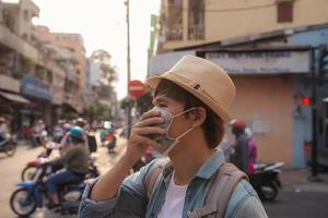Traveller wears disposable facial surgical mask as a protection from infection. photo