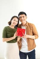 Young beautiful couple with present isolated on white background photo