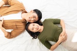 Romantic couple in love looking at each other.. Top view of smiling young couple photo