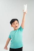 funny Child with glass of milk.Little Boy enjoy milk cocktail. Healthy life photo