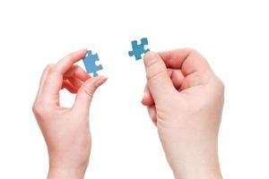 male and female hands with little puzzle pieces photo