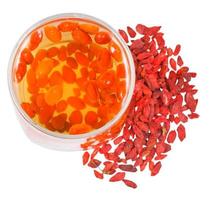 top view of glass goji berries infusion and fruits photo