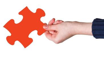female hand with red puzzle piece photo