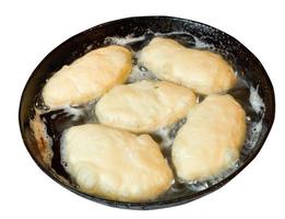 patties frying in pan isolated on white photo