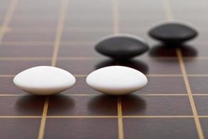 few stones during go game playing photo