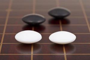 four stones during go game playing on goban photo