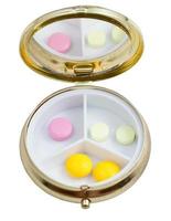 compact pill box with several tablets photo