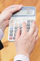 above view of calculator in male hands photo