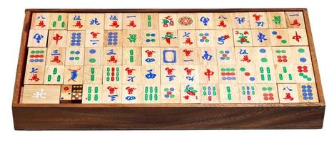 mahjong game tiles in box isolated on white photo