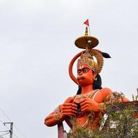 New Delhi, India - June 21, 2022 - Big statue of Lord Hanuman near the delhi metro bridge situated near Karol Bagh, Delhi, India, Lord Hanuman statue touching sky photo