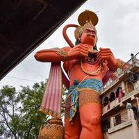 New Delhi, India - June 21, 2022 - Big statue of Lord Hanuman near the delhi metro bridge situated near Karol Bagh, Delhi, India, Lord Hanuman statue touching sky photo