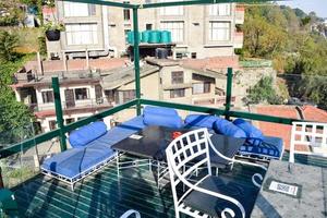 Kasauli, Himachal Pradesh, India, May 15,2022 - Early morning view of Modern rooftop restaurant at Kasauli, View of mountain hills from open air restaurant in Kasauli, Kasauli Rooftop restaurant photo