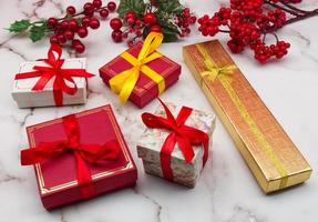 Christmas gift boxes isolated on marble table. Christmas decorations. photo