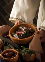 A close up shot of a dolma covered in grape leaves photo