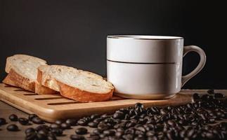 bread for breakfast, with cup of coffee over rustic wooden background with copy space. Morning breakfast with coffee and toasts. photo