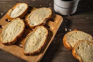 bread for breakfast, with cup of coffee over rustic wooden background with copy space. Morning breakfast with coffee and toasts. photo