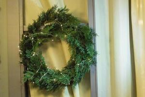 Christmas wreath with lights garland . Homemade creative handmade decor for home photo