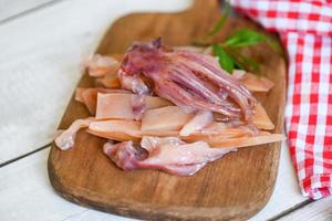 raw squid for cooking food on wooden, preserving food seafood, pickled squid on the kitchen photo