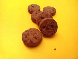 mini chocolate chip cookies on yellow background. for backgrounds, covers, banners and more. photo