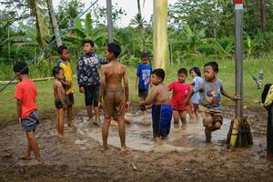 Blitar, Indonesia - September 11, 2022. Some children are ready to take part in a banana tree climbing competition to commemorate Indonesian Independence in Blitar photo