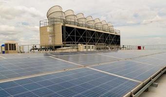 Hot climate and Sets of cooling towers cause increased power production,Alternative energy to conserve the world's energy, rooftop solar and cooling systems. photo