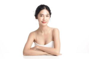 Asian woman with a beautiful face and Perfect clean fresh skin. Cute female model with natural makeup and sparkling eyes on white isolated background. Facial treatment, Cosmetology, beauty Concept. photo