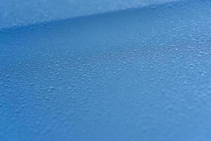 Raindrops on the hood of the car. Close-up. photo