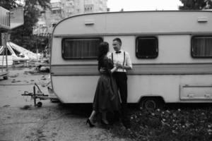 man and woman is hidden from view behind a trailer photo