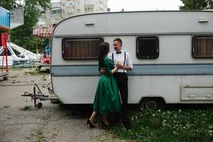 man and woman is hidden from view behind a trailer photo