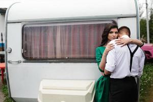 man and woman is hidden from view behind a trailer photo