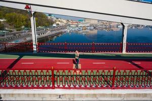 Beautiful Energetic Fitness Girl Doing Exercises on Bridge. photo