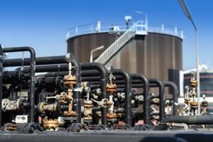 Industrial zone, Steel pipelines, valves, oil tank, cables and walkways photo