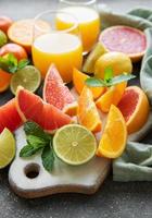 Glasses of juice and citrus fruits photo