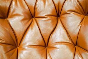 primer plano y fondo de cuero de sofá marrón de cultivo. foto