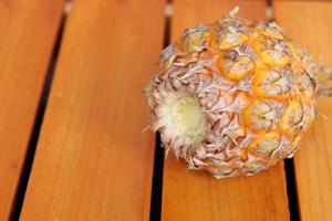 Pineapple isolated on a wooden background photo