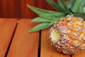 Pineapple isolated on a wooden background photo