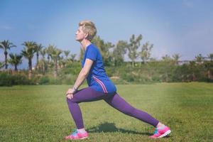 female runner warming up and stretching photo