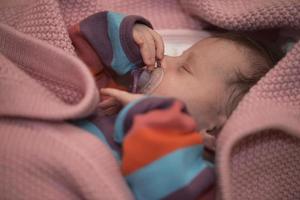 One month newborn baby sleeping  in bed photo