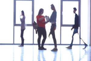 student girl standing with laptop, people group passing by photo