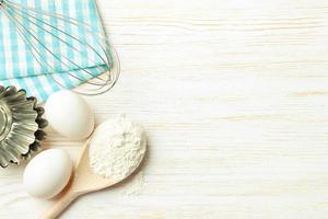 Baking ingredients on white wooden background photo