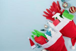 Christmas cleaning. Cleaning tools and Christmas decorations top view flat lay on blue background with copy space photo