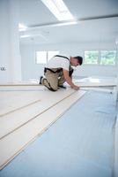 Worker Installing New Laminated Wooden Floor photo
