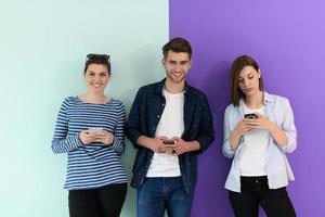 a group of teenagers use mobile devices photo