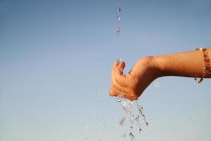 fresh water falling on children hands photo