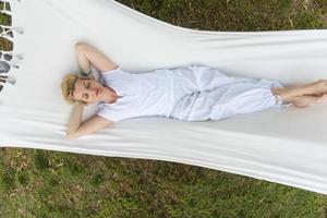 young woman resting on hammock photo