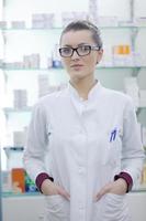 pharmacist chemist woman standing in pharmacy drugstore photo