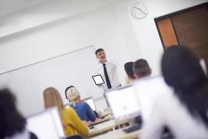 students with teacher  in computer lab classrom photo