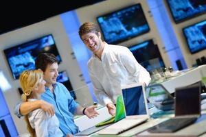 People in electronics store photo